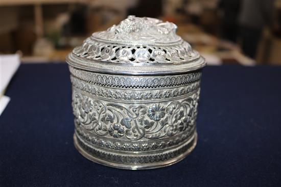 A Burmese silver teardrop shaped box with pierced cover containing minor items of jewellery.